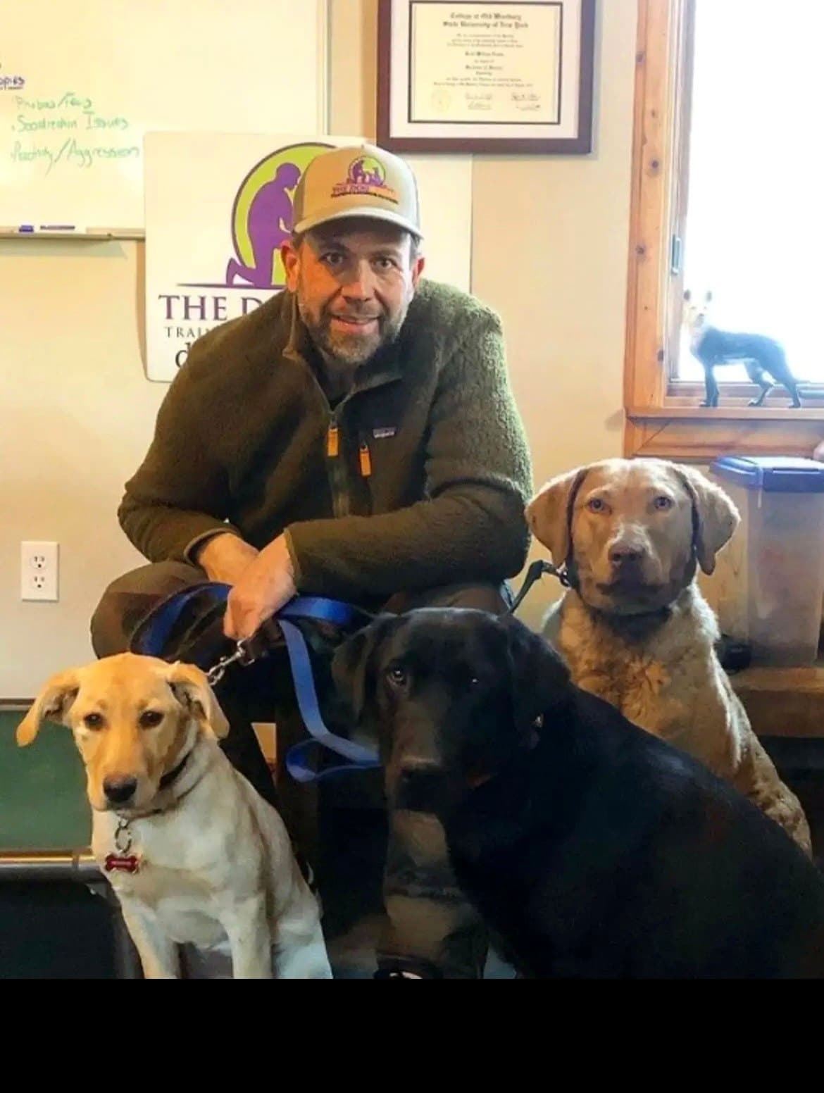 Brett Endes with three calm dogs after a training session