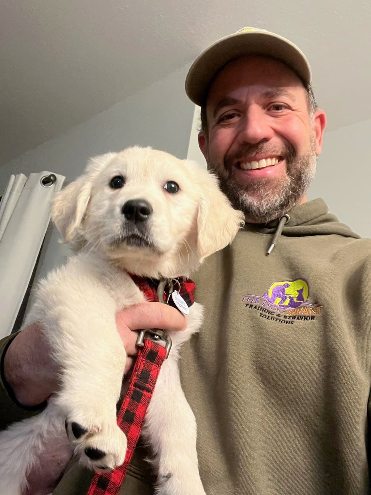 Brett Endes holding a golden retriever puppy
